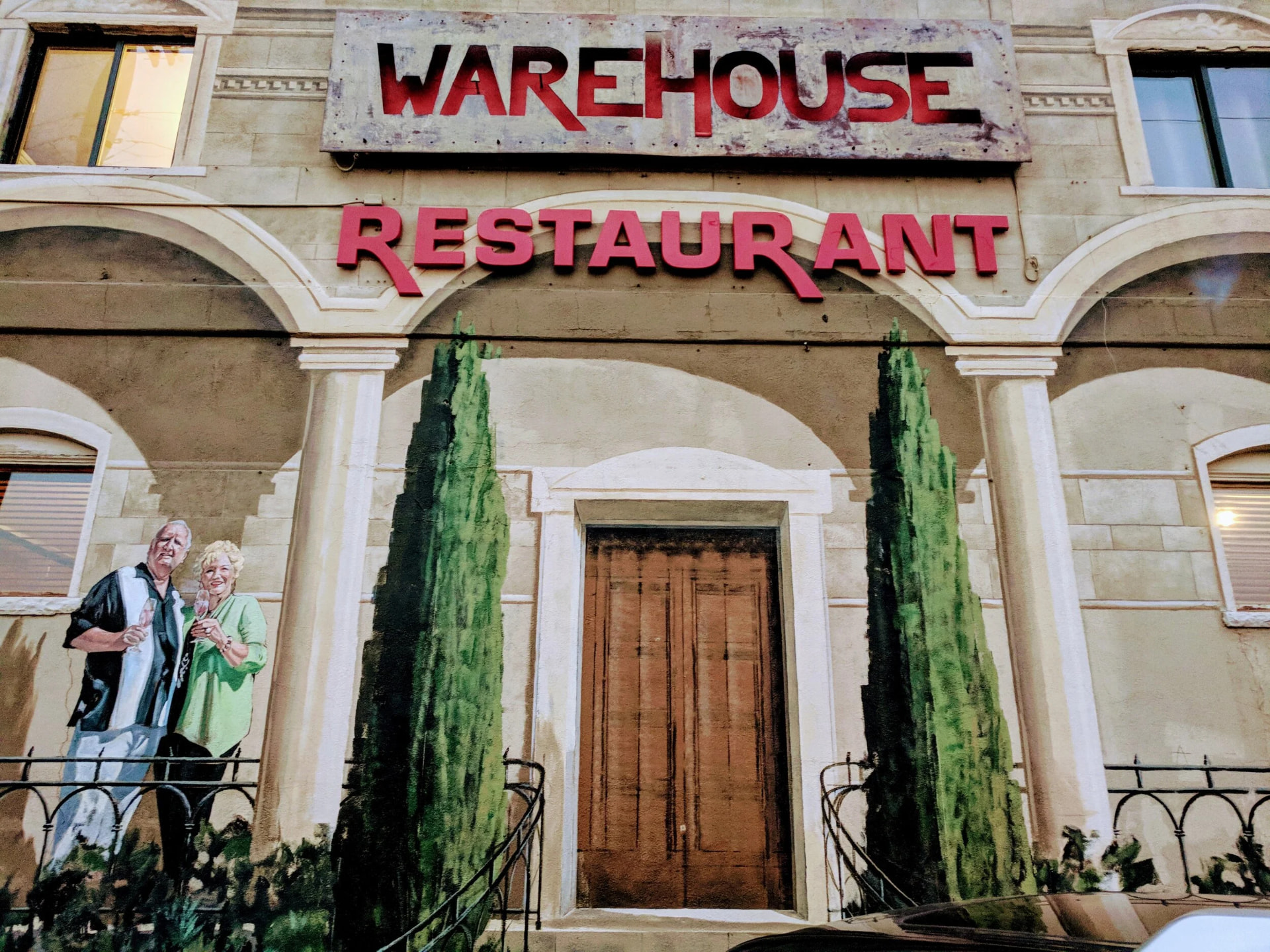 Trompe-l'oeil Italian courtyard mural on The Warehouse Restaurant facade